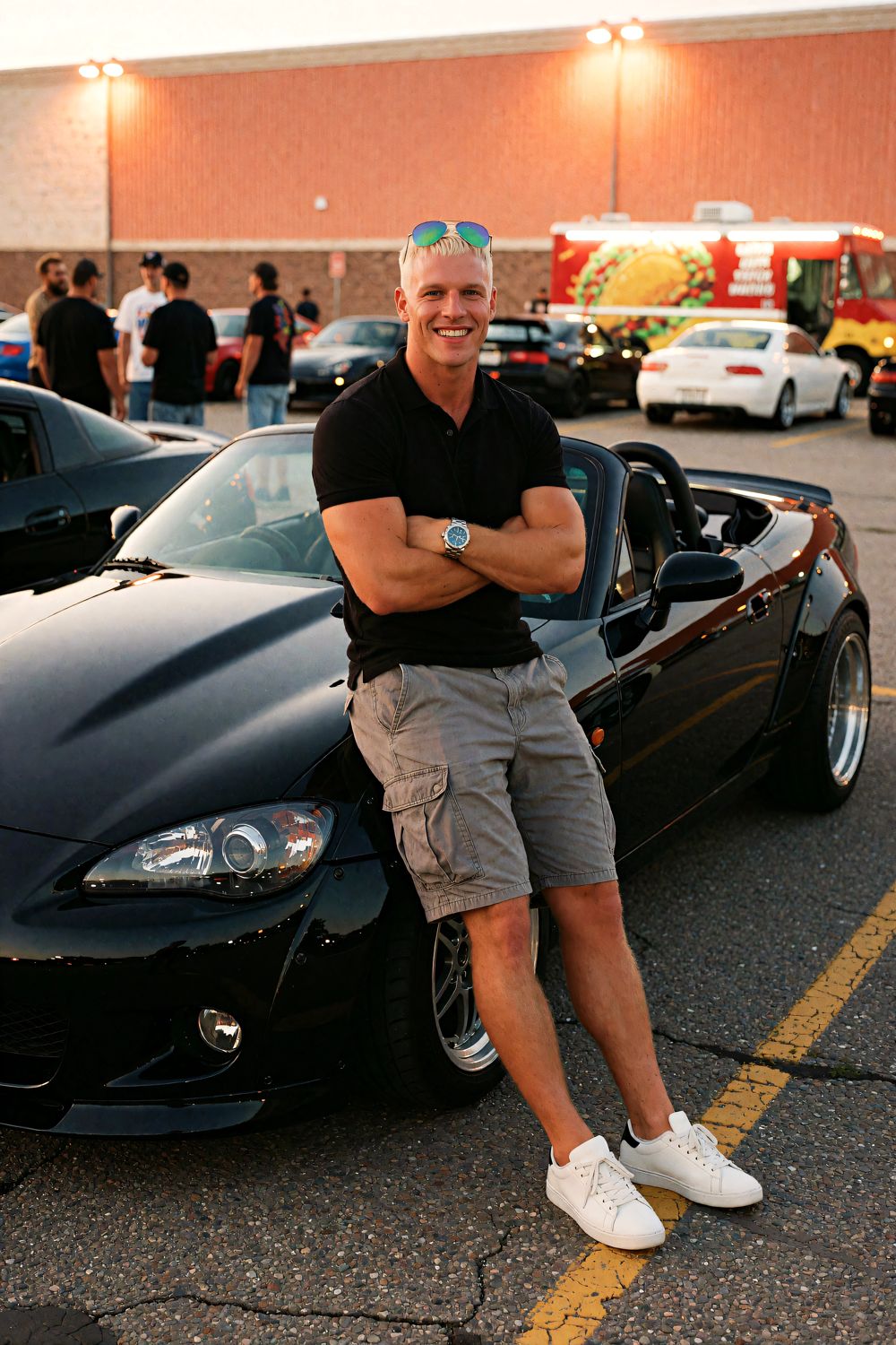 Trent leans on his black sports car